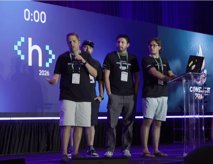 Four members of Team ConstantPray standing on stage at the Gloo AI Hackathon 2026, in front of a large screen showing the event logo.